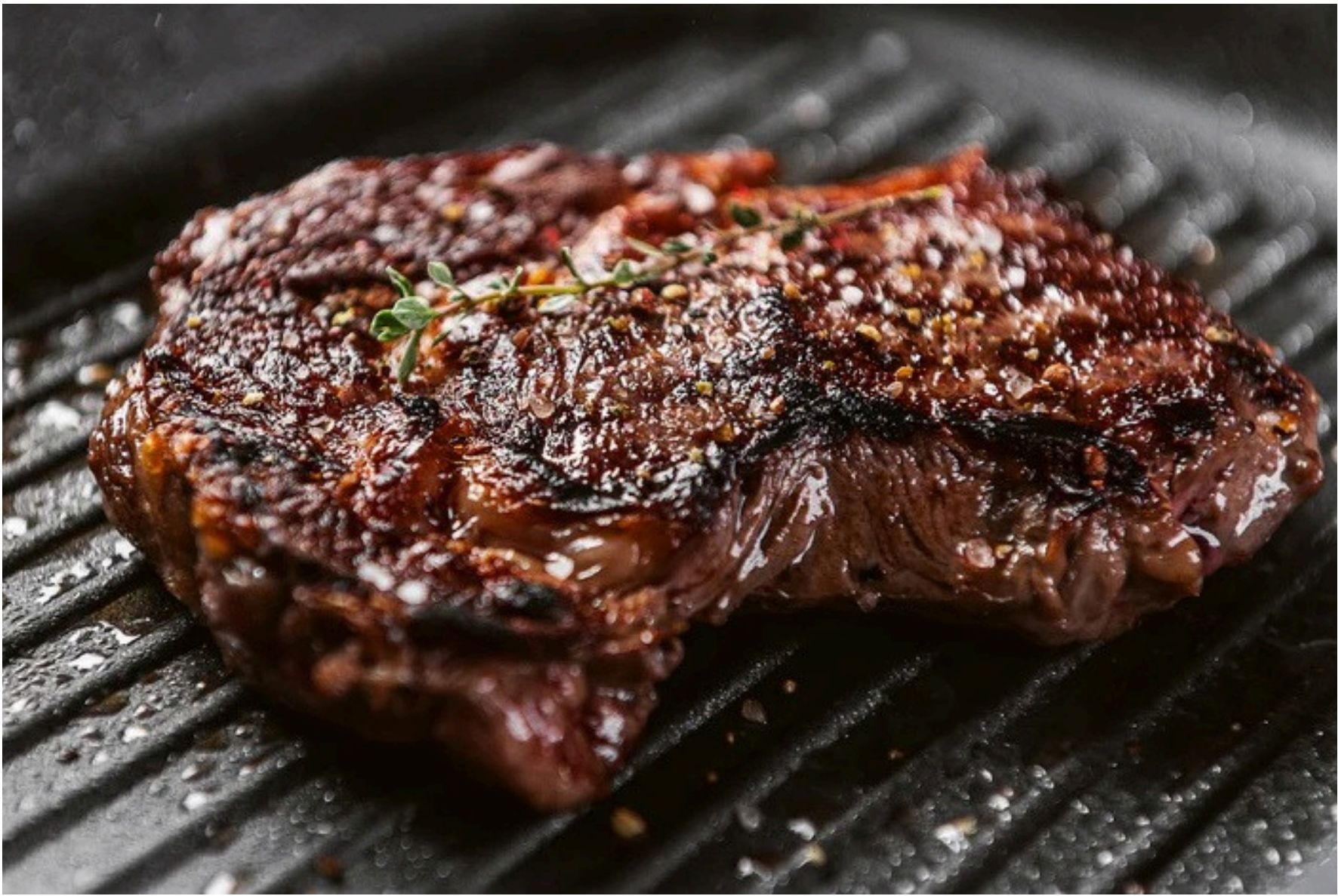 A cooked bone-in sirloin steak on a grill