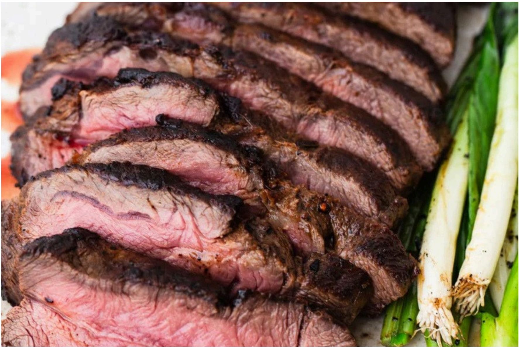 Sliced flat iron steak with green onions