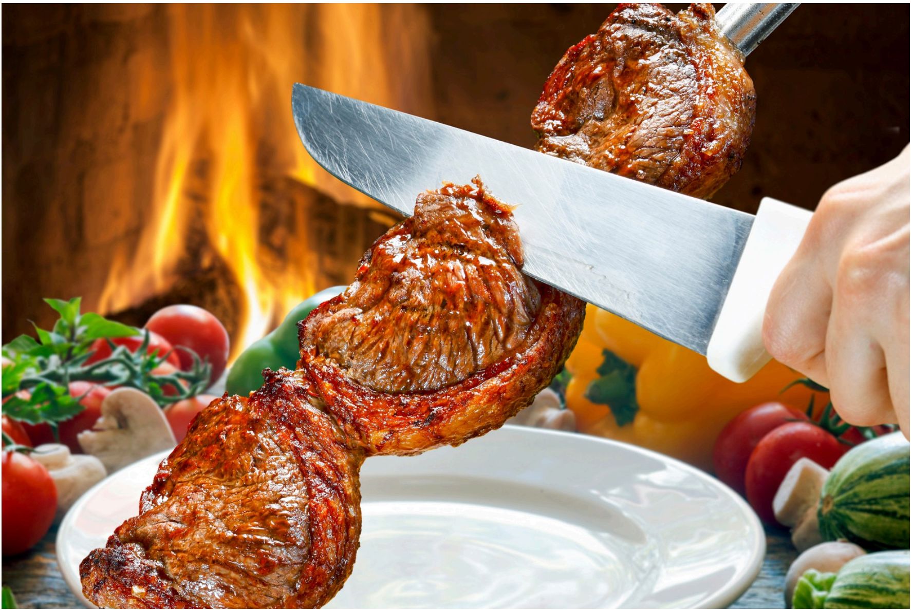 Picanha steak being sliced on a skewer