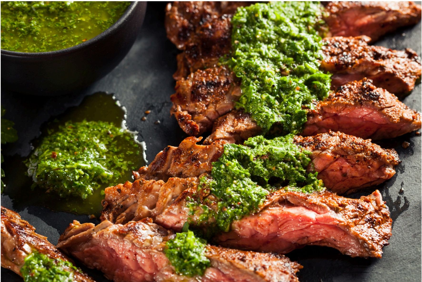 Sliced skirt steak with green sauce